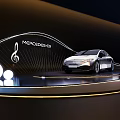 Mercedes Benz Silver Electric Sedan Display With Wavy Lines Musical Notes And Glowing Spheres