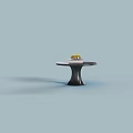 Stylish Black Round Table with Unique Pedestal Base and Decorative Books Small Plant
