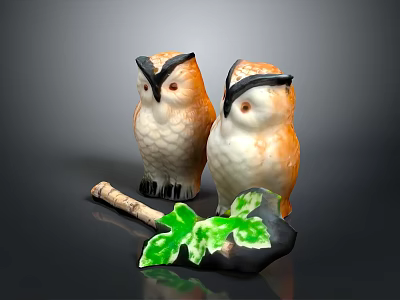 Two Ceramic Owl Figurines With Brown Feathers And Green Leaf Decor 3d model