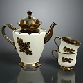 Elegant White Teapot With Gold Accents And Black Floral Pattern Cups