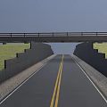Urban Asphalt Road With Yellow Lines Under Bridge And Concrete Wall Along Green Grass