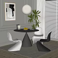 Modern Round Black Dining Table With White And Black Chairs And Green Plant