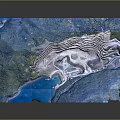 Mountainous Terrain With Rolling Hills Green Vegetation And Blue Water Bodies