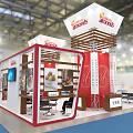Orthoworks Exhibition Booth Featuring Red Structure White Canopy Multiple Columns And Visitors
