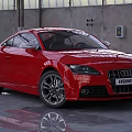 Red Audi Coupe Car In Industrial Workshop With Shiny Exterior And Alloy Wheels