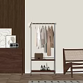 Metal Clothes Rack Hanging Shirts Coats With Lower Shelf Holding Bag And Bottles Near Cabinet