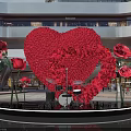 Heart Shaped Rose Art Installation With Red Roses Around Black Platform And Drums