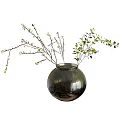 Round Glass Vase With Green Leaves And Small Branches Floral Arrangement