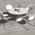 Modern White Round Dining Table With Four White Chairs Black Legs Green Cushions And Vase