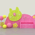 Interactive Area With Green Cat Shaped Decoration Pink Curved Background Flower Patterns And Colorful Balls