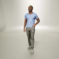 A Man In Blue T Shirt And Gray Pants Smiling Standing On Light Background
