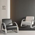 Modern Minimalist Armchair with Black and Beige Upholstery and Silver Metal Frame on Neutral Walls