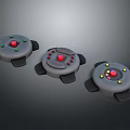 Three Round Weapon Devices Featuring Red Green Yellow Buttons And Black Stands