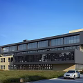 Contemporary Industrial Factory Building With Large Glass Facade Steel Structure And Green Surroundings