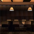 Elegant Private Room Interior With Long Table Chairs Vertical Slat Wall And Pendant Lights