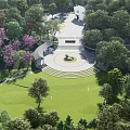 Lush Public Park With Green Lawn Circular Square Trees And White Building Steps