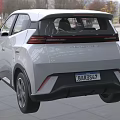 White Compact Car with Modern Sleek Front Design LED Headlights in Indoor Showroom Setting