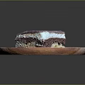 Delicious Purple Coated Layered Cake With Cream Filling On Wooden Plate