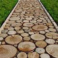 Scenic Garden Pathway Paved With Wooden Slices And Green Grass