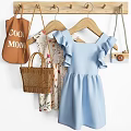 Stylish Clothing Hanger With Blue Ruffled Dress Woven Handbag And Camera Accessory