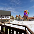 Scenic Public Square With Traditional Buildings Colorful Artworks Domes And Mountain Views