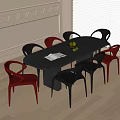 Modern Black Oval Dining Table with Eight Red and Black Chairs Fruit Bowl and Napkin