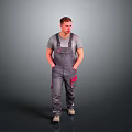 Male Worker In Gray Overalls With Red Pockets Standing On Gray Background
