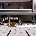 Modern Commercial Street With Stylish Storefronts Pedestrian Walkway And Outdoor Decorative Plants