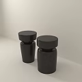Two Black Modern Stools With Solid Black And Dark Speckled Textures Against Light Minimalist Background 3d model