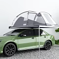 Green Car With Roof Tent For Outdoor Camping Featuring Tree And Gravel Ground