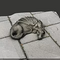 Intricately Carved Dragon Sculpture Lying On Gray Stone Tiles Surface