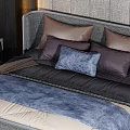 Double Bed with Textured Gray Wall Black Gold Butterfly Decorations Purple Blue Pillows and Bedside Lamps