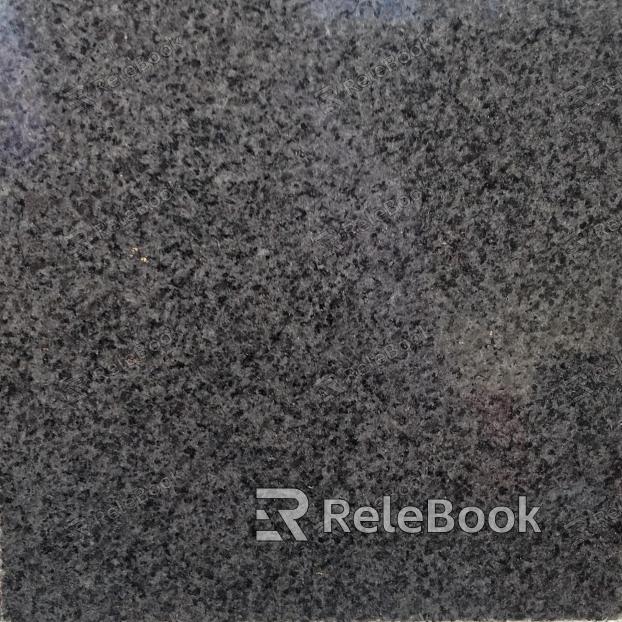 A close-up texture shot of granite, showcasing its characteristic flecks of white, grey, and black in a rugged, natural pattern. The stone's polished surface reflects light, highlighting its depth and complexity.