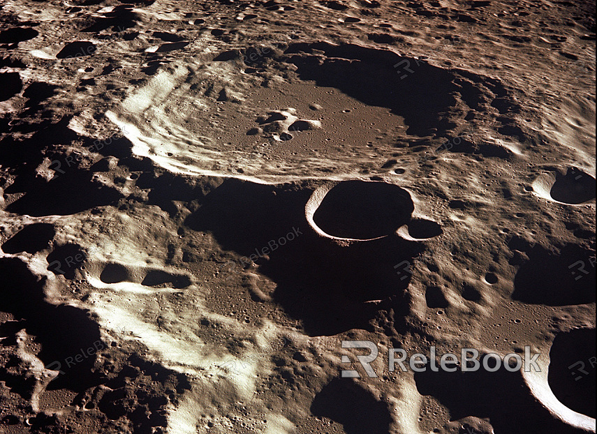 The image depicts a rugged, cratered landscape of the moon's surface, bathed in stark sunlight, showcasing its barren and rocky terrain with shadows accentuating the topography.