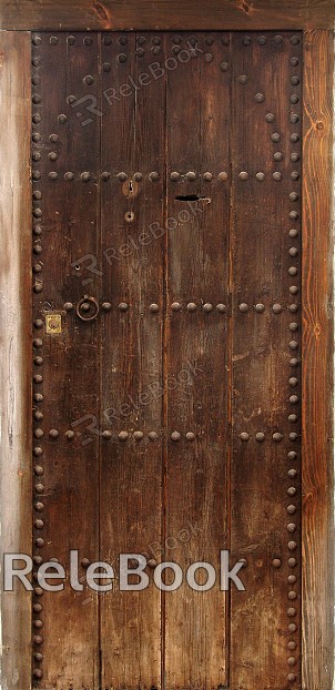 A vintage wooden door with intricate carvings and a distressed finish, adorned with antique metal hardware, evoking a sense of history and charm.