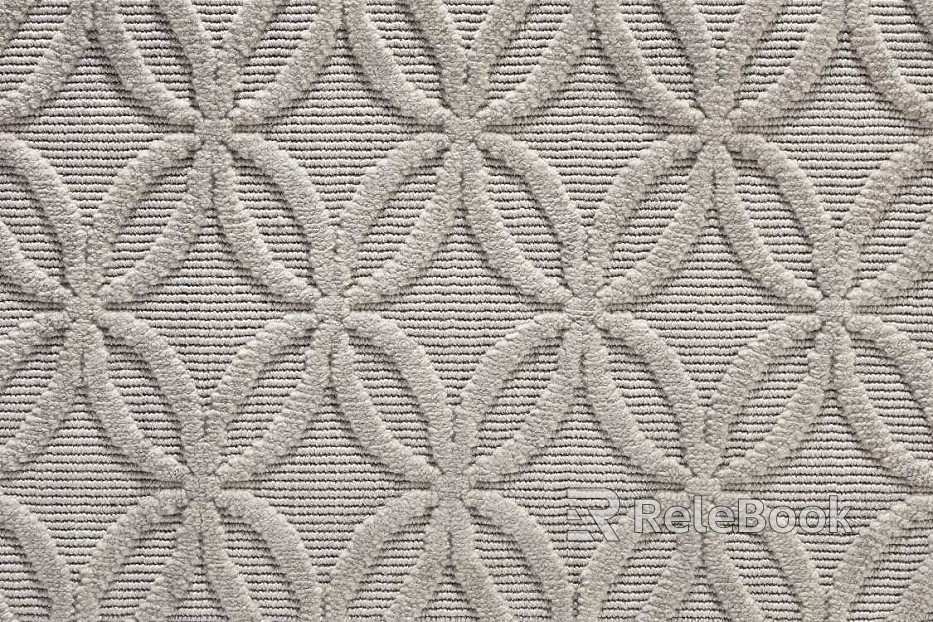 A modern square carpet featuring an abstract geometric pattern in shades of gray, white, and black, with a soft, plush texture for added comfort and style.