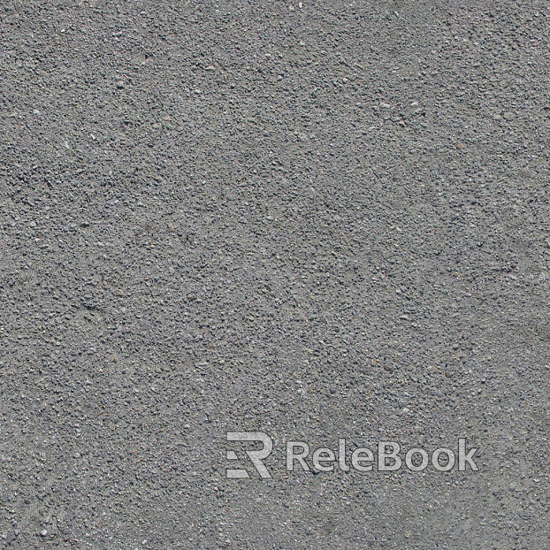 A gritty, textured image of gravel, showcasing small stones and pebbles in various shades of gray and brown, set against a backdrop of what appears to be a concrete or asphalt surface.