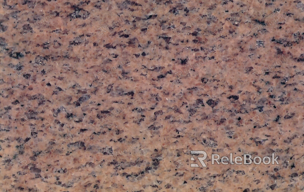 A close-up texture shot of granite, showcasing its characteristic flecks of white, grey, and black in a rugged, natural pattern. The stone's polished surface reflects light, highlighting its depth and complexity.