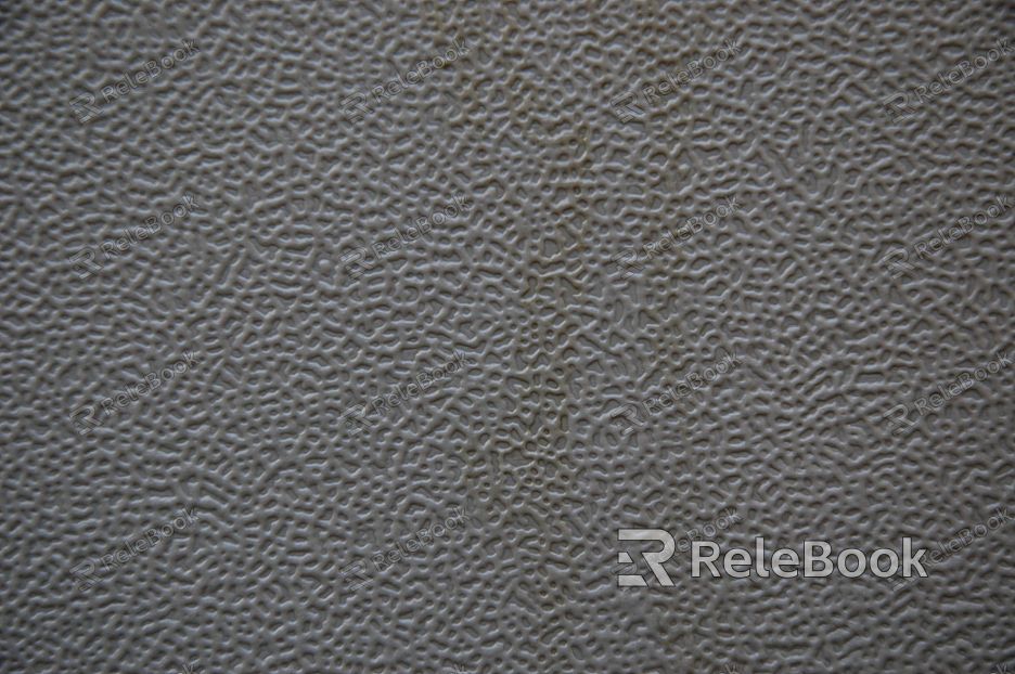 A close-up image of a brushed metal surface, showcasing its fine linear textures and metallic sheen under the light.