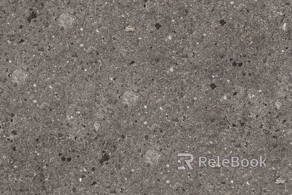 A gritty, textured image of gravel, showcasing small stones and pebbles in various shades of gray and brown, set against a backdrop of what appears to be a concrete or asphalt surface.