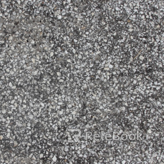 A gritty, textured image of gravel, consisting of small stones and pebbles in various shades of gray, brown, and black, set against a blurred background.