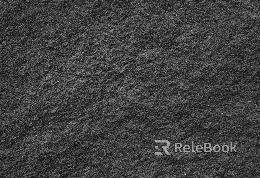 A close-up of a rugged, gray rock surface with deep crevices and uneven texture, illuminated by soft, diffused light that highlights its natural patterns and mineral composition.