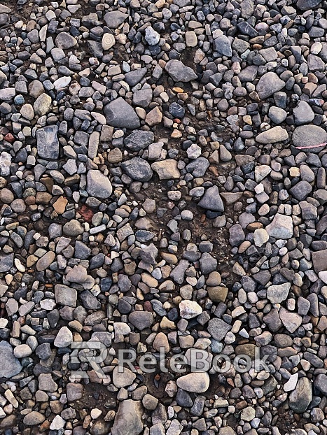 A coarse, granular material predominantly featuring pebbles and fragments of rock, this gravel texture showcases a mix of earthy tones from light beige to dark grey, presenting a natural and rugged surface.