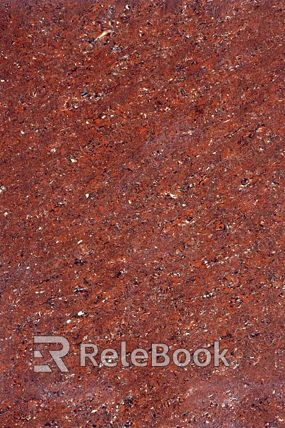 A close-up texture shot of granite, showcasing its characteristic flecks of white, grey, and black in a rugged, natural pattern. The stone's polished surface reflects light, highlighting its depth and complexity.