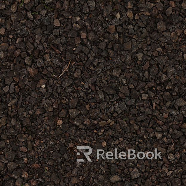 A gritty, textured image of gravel, consisting of small stones and pebbles in various shades of gray, brown, and black, set against a backdrop of what appears to be a concrete or asphalt surface.