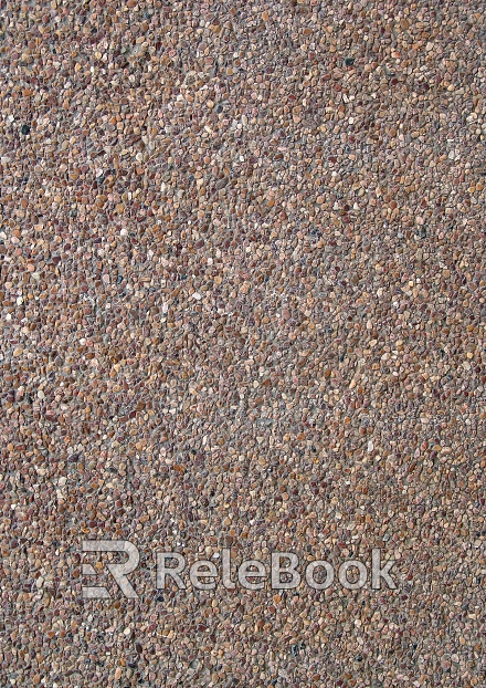 A coarse, granular material, this image showcases a textured surface of gravel, comprised of various sizes of small stones and pebbles, predominantly in shades of gray and brown.