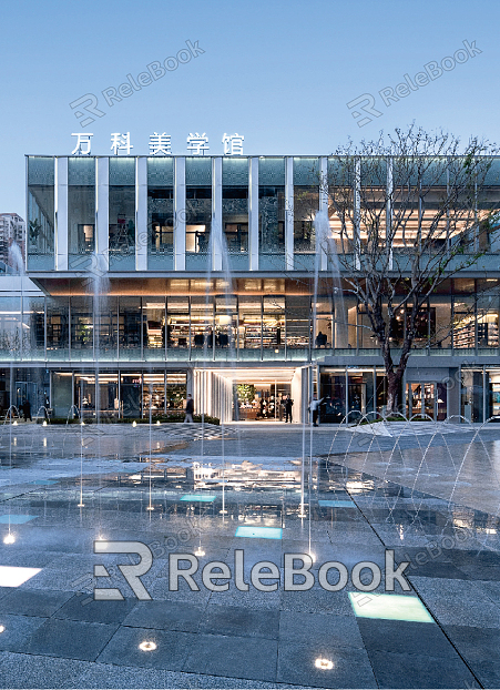 The image showcases an exterior view of a modern, industrial building with large glass windows and steel beams, set against a cloudy sky, creating a contrast between the man-made structure and nature.