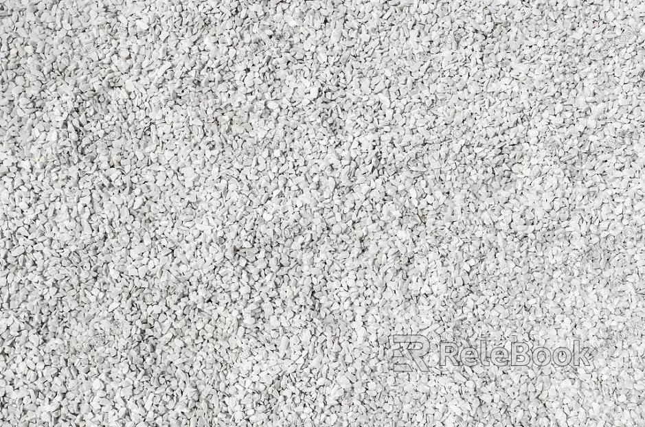 A coarse, granular material, this image showcases a textured surface of gravel, comprised of various sizes of small stones and pebbles, predominantly in shades of gray and brown.