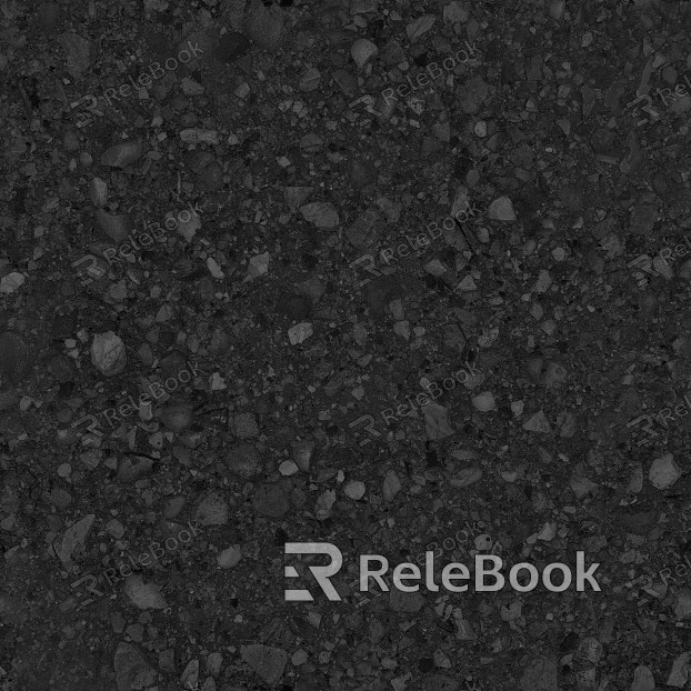 A gritty, textured image of gravel, showcasing small stones and pebbles in various shades of gray and brown, set against a backdrop of what appears to be a concrete or asphalt surface.