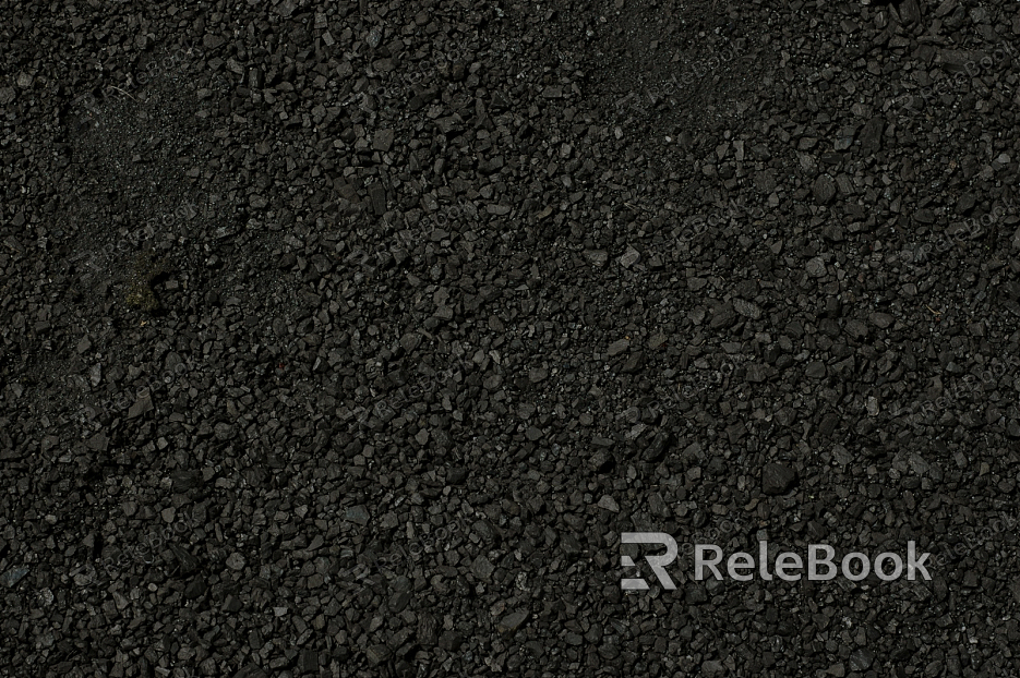 The image depicts a close-up of gravel, showcasing an assortment of small stones with rough, textured surfaces, varying in shades of gray and brown.